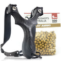 Black slingshot with a package of yellow ammunition on a white background