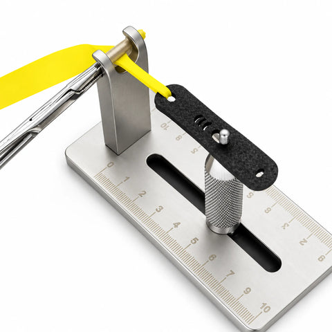Band tying jig in use — pouch and flat band held at tension for a consistent tie