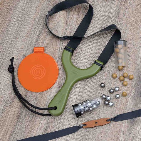 Hornet slingshot flat lay with bandsets, clay and steel ammo, lanyard and tape